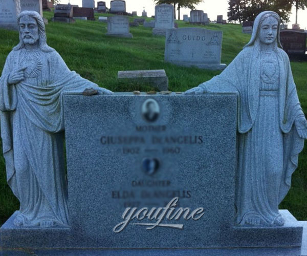 Religious cemetery headstone with grave decoration Jesus and Mary statue