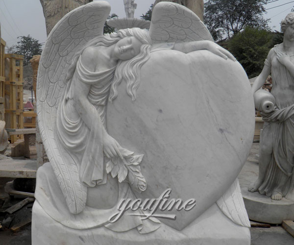 Upright stone carved fallen angel hold heard memorial